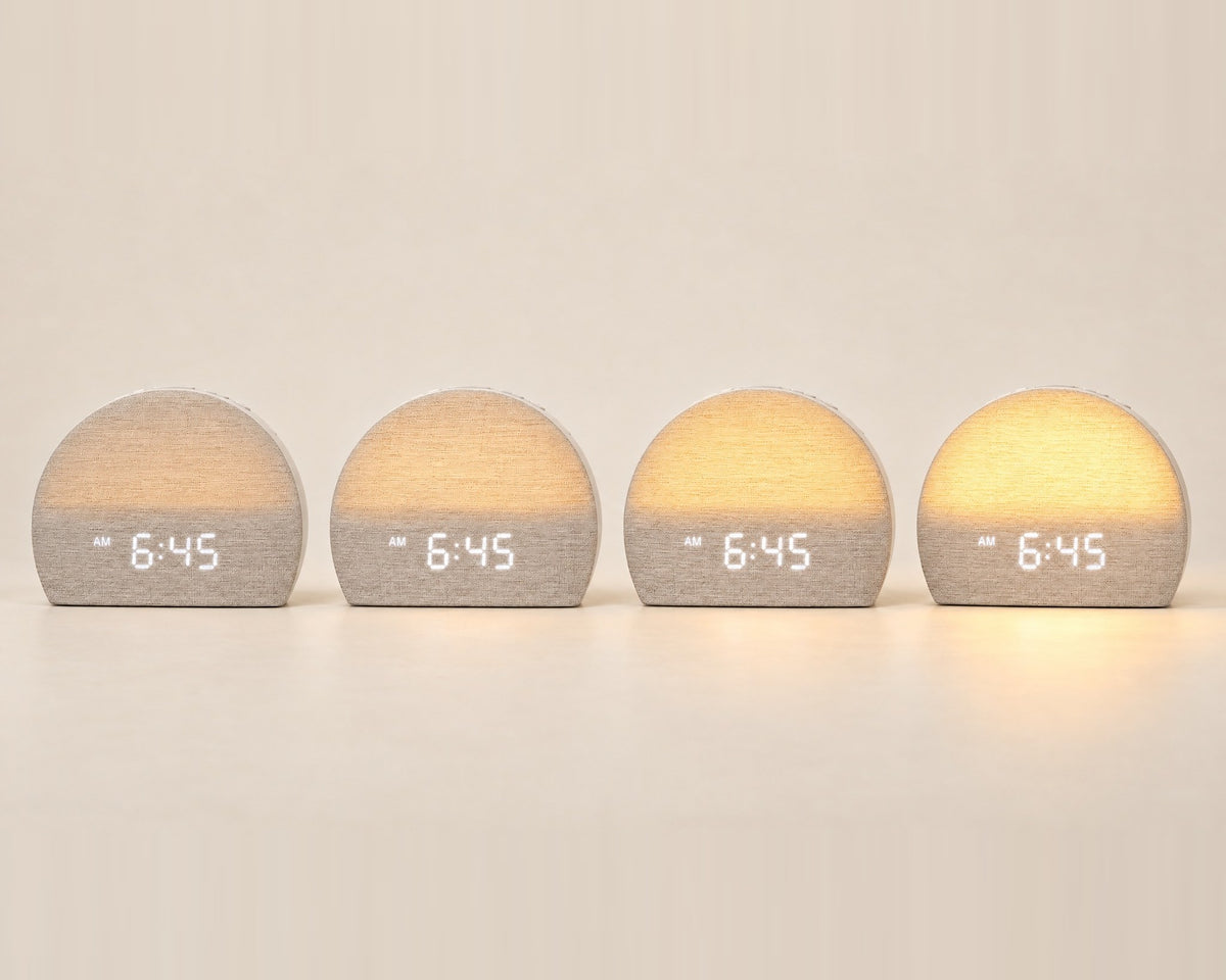 Four Sunrise Clocks showing how the light builds from a faint glow to full warm light